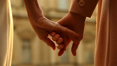 two generations holding hands
