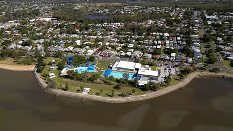 aerial view of sandgate pool moving left to right and brighton waterfront on a sunny day, brisbane, queensland, australia