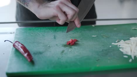 chopping red chili on cutting board