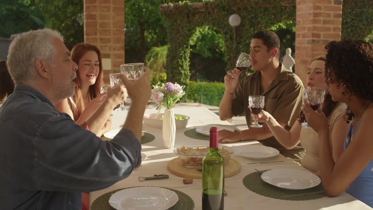 Joyful Family and Friends Social Gathering Outdoors with Wine