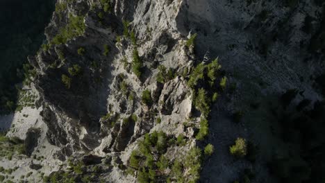 aerial over backcountry mountain range and forest at sunset