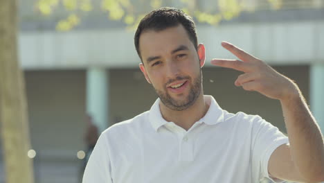 Handsome-young-man-showing-various-signs-outdoor.