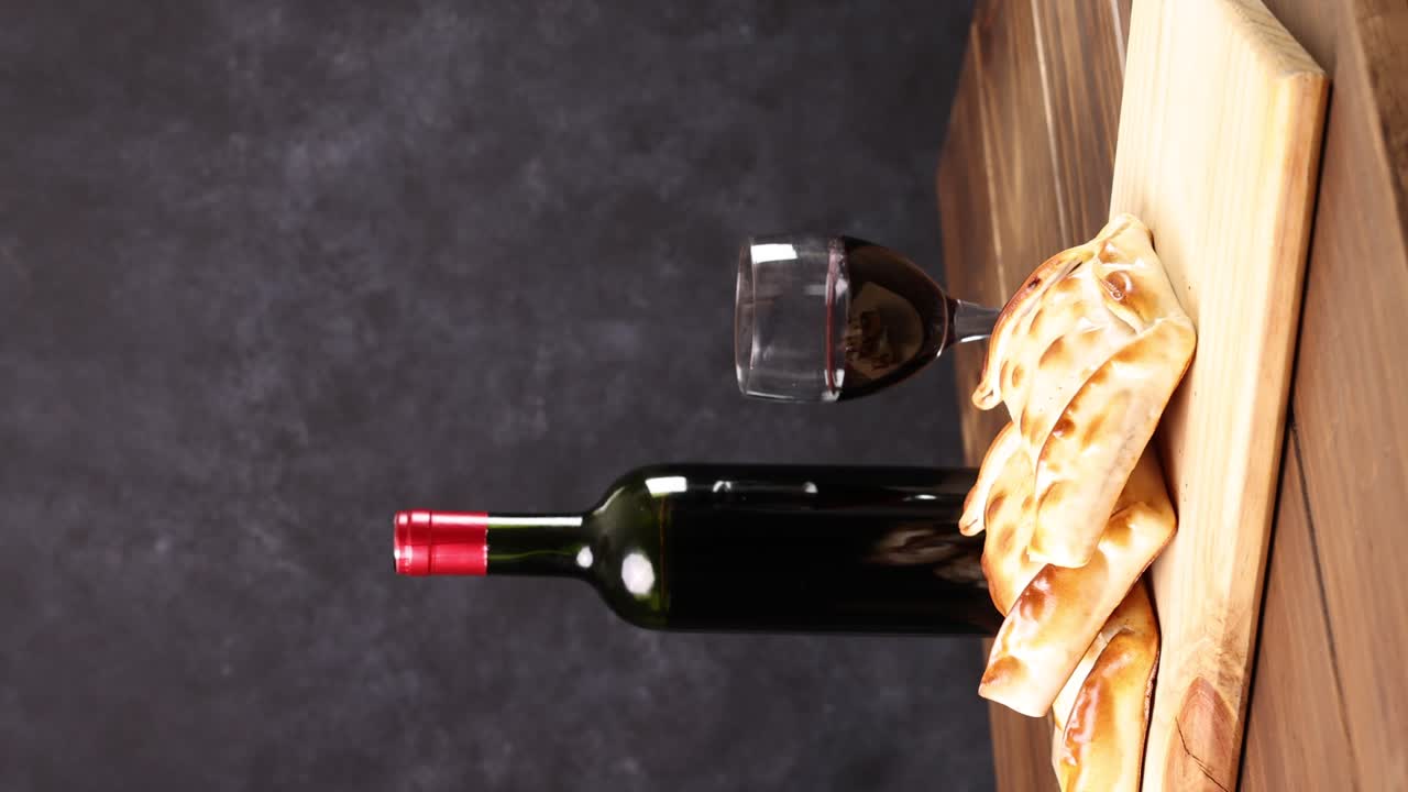 Chilean wine glasses and bottle and empanadas variety