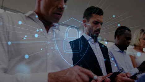 animation of shield with padlock over diverse colleagues using smartphones