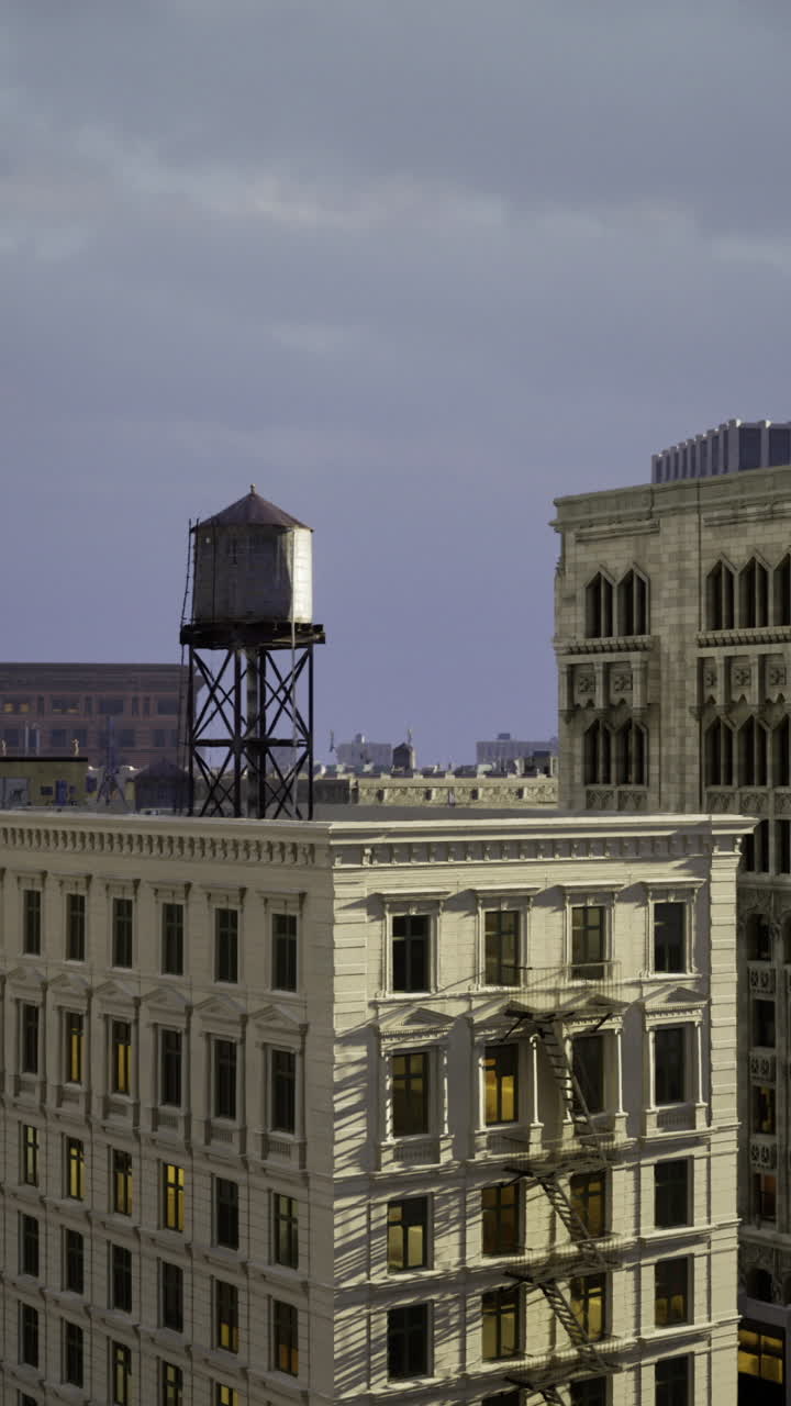 View of urban skyline at twilight with vintage water tower atop building