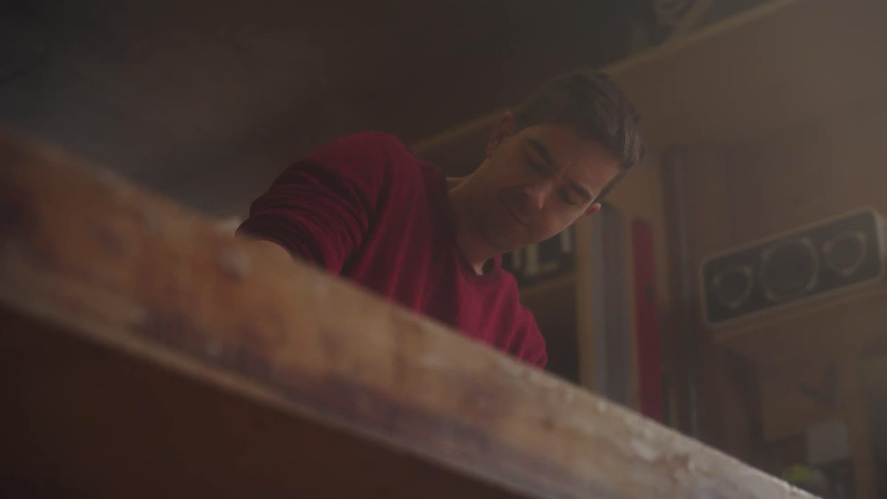 A craftsman works at his table in the workshop