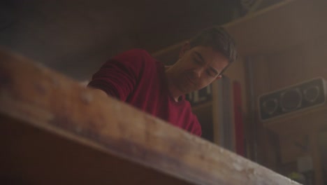 a craftsman works at his table in the workshop