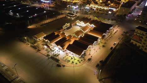 Aerial-orbiting-shot-of-a-food-court-lit-up-in-the-Boten-Special-Economic-Zone-at-night