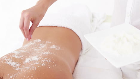 woman getting a salt scrub treatment