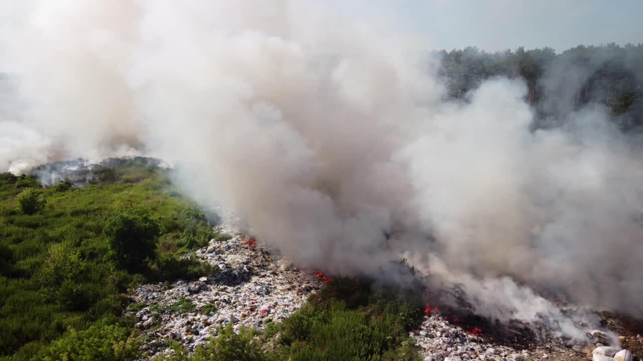 Circling around dump site exhaling dangeround smokes in the countryside