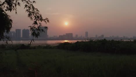 Aerial-drone-footage,-Phnom-Penh-skyline-in-Cambodia-at-sunset