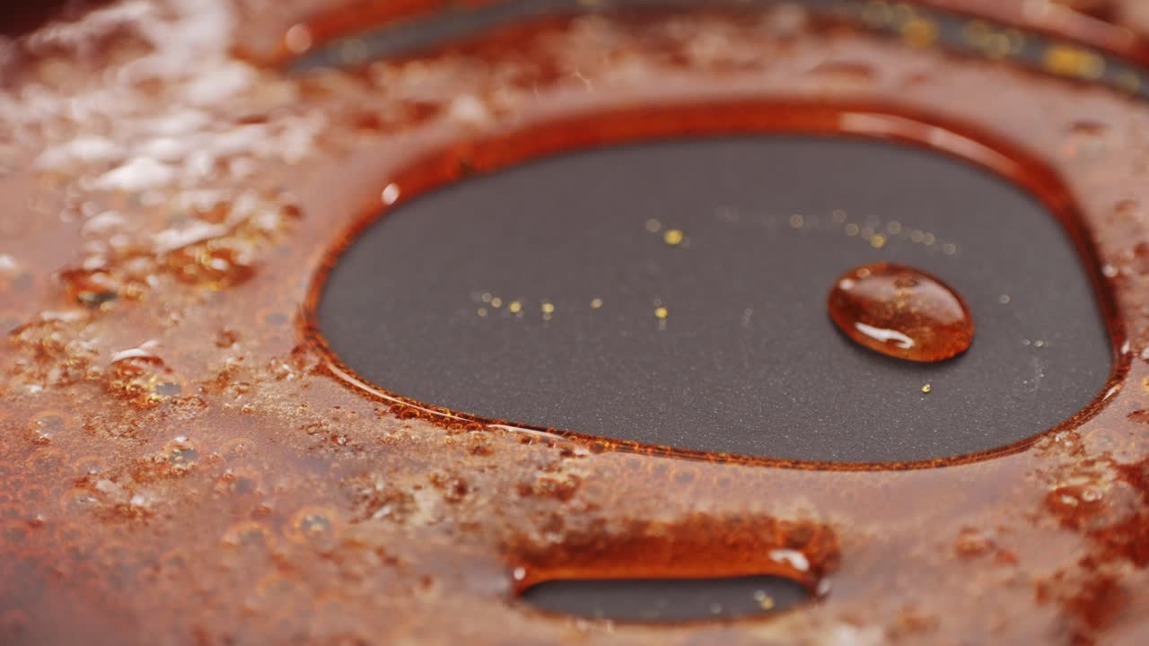 Close up of boiling sugar with bubbles turns into caramel, caramelization, chef cooking dessert in cafe, restaurant pastry food.