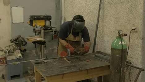 mig welder fabricating steel structure wide shot