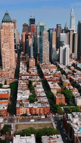 approaching gorgeous skyscrapers in the new york midtown. sunny panorama of the city from aerial perspective. vertical video