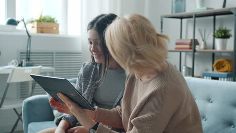 grandmother and granddaughter using tablet