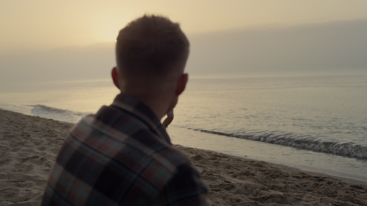 Affectionate couple dating on sea beach at sunrise. Girl running along coastline