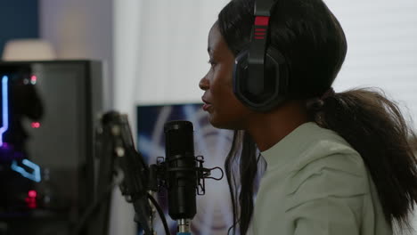 african american esport streamer talking into micrphone