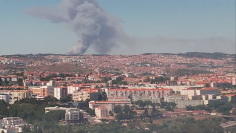 zoom shot  of the lisbon city fire event from a distance, visible clouds of smoke
