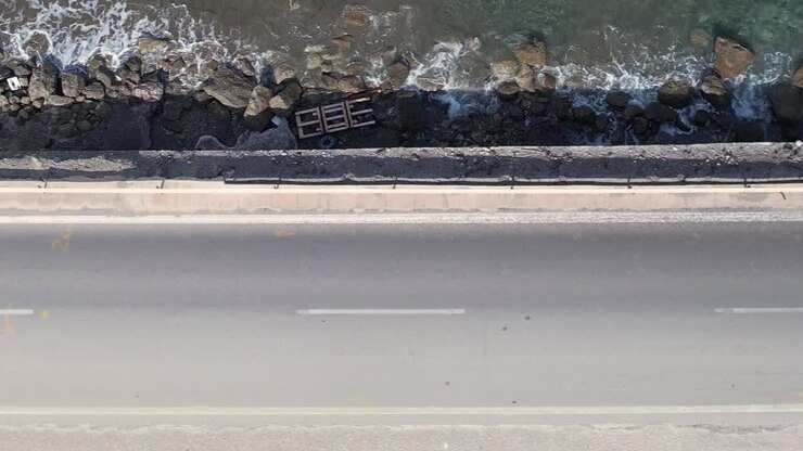 Stunning aerial view of a coastal road in Greece near the waves