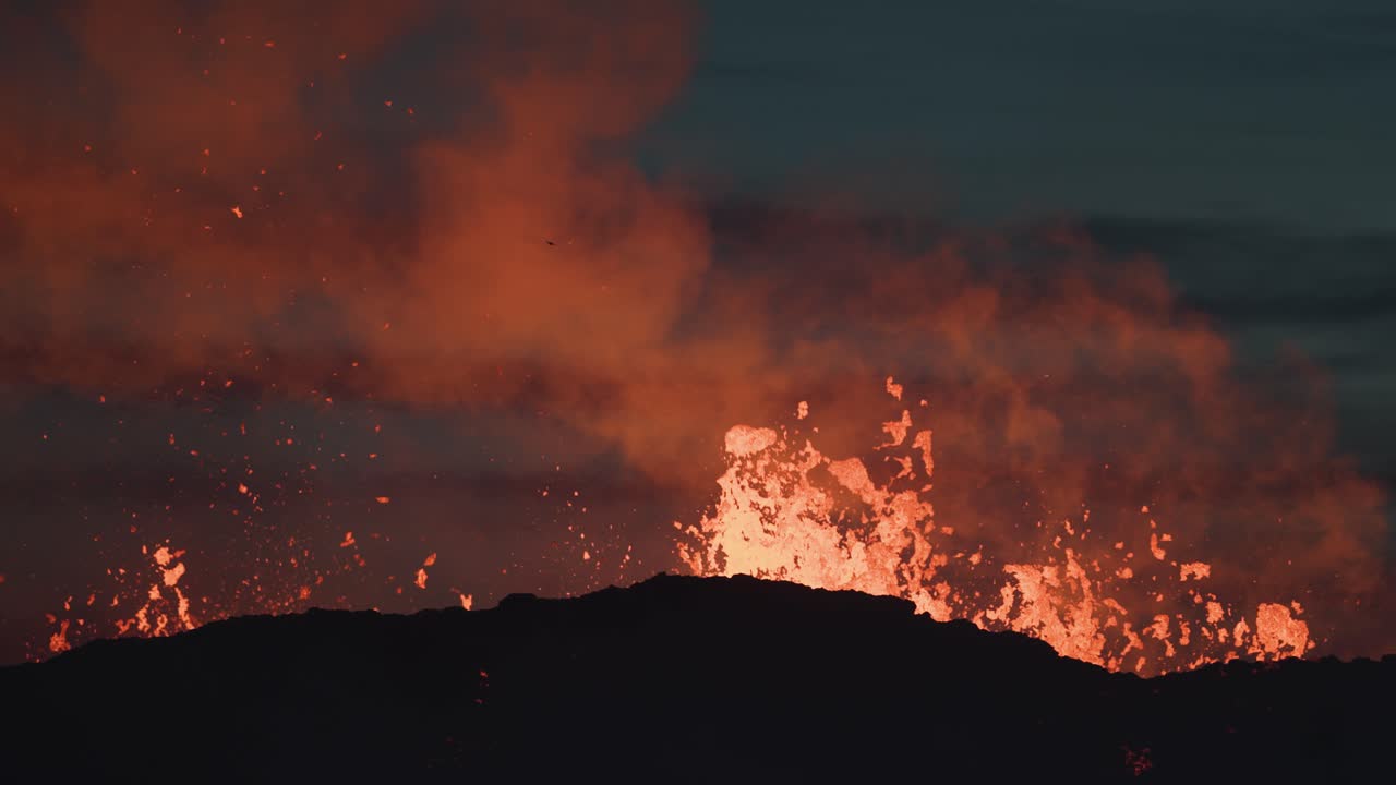 Fiery molten lava exploding from volcano crater Litli-Hr&uacute;tur in Iceland