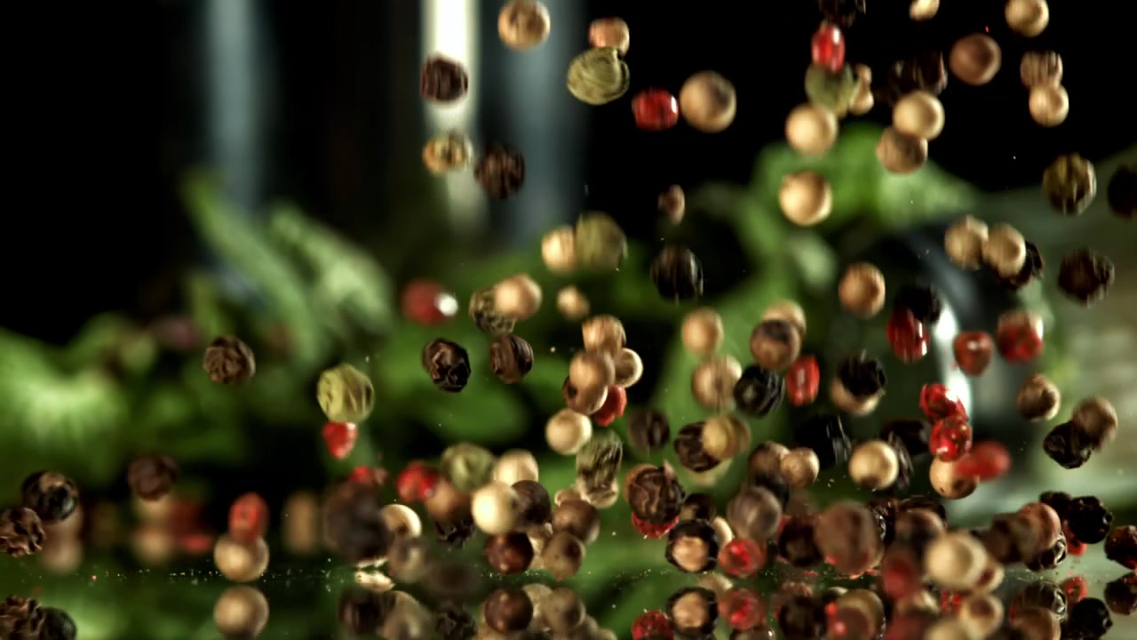 Mixed Peppercorns Falling in Super Slow Motion