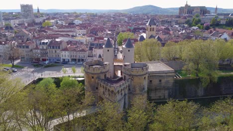 Aerial-Medieval-German-Gate-Castle-Towers-over-Seille-river-In-Metz-France