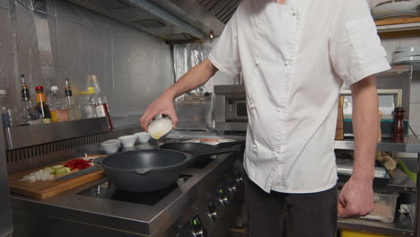adding oil to wok pan