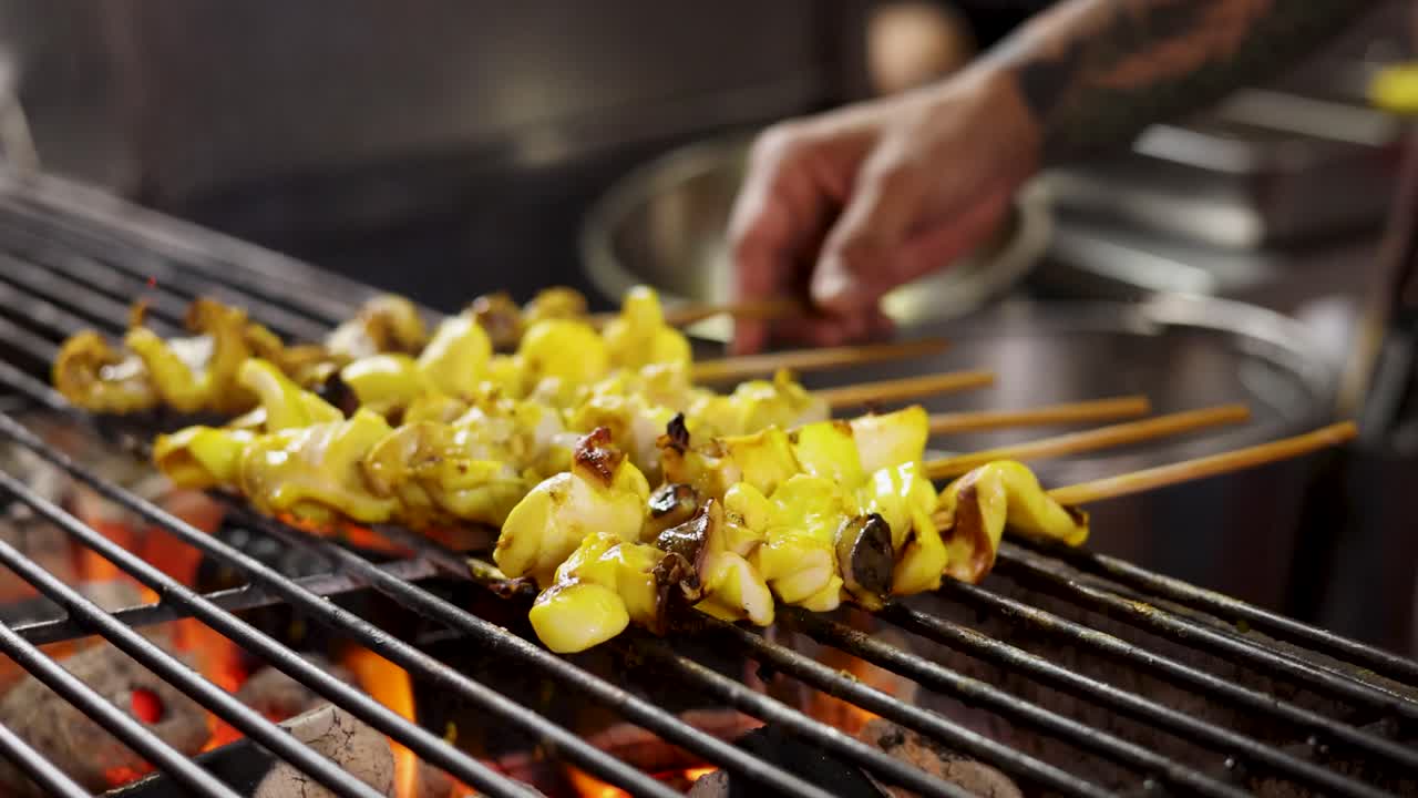 Vendor grills squid skewers over open flame, close-up view, warm lighting, shallow depth of field