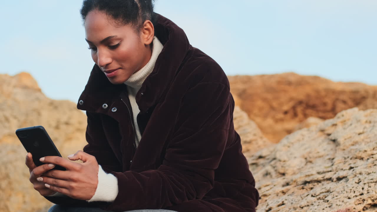 African American girl using mobile phone.