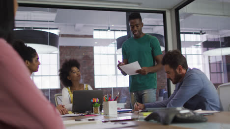 Mixed-race-business-colleagues-sitting-having-a-discussion-in-meeting-room