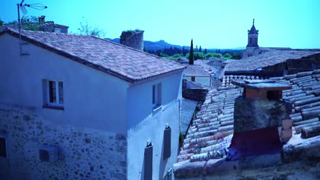 streets of a keolien french village through small alley over the roofs to a small church