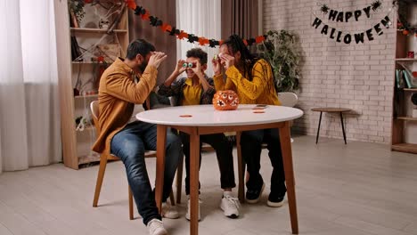 family having fun with candy eyeballs during halloween festivities