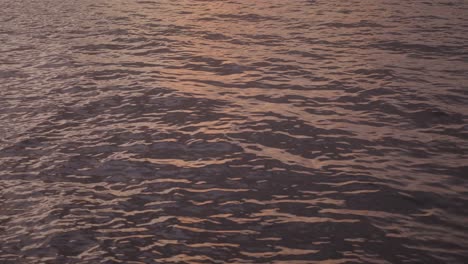 tranquil sunset reflections of abstract patterns on a tropical water's surface in the evening