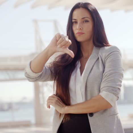 disappointed businesswoman giving a thumbs down