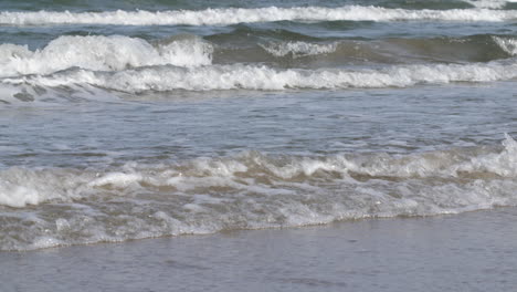 slow motion waves roll on to the beach