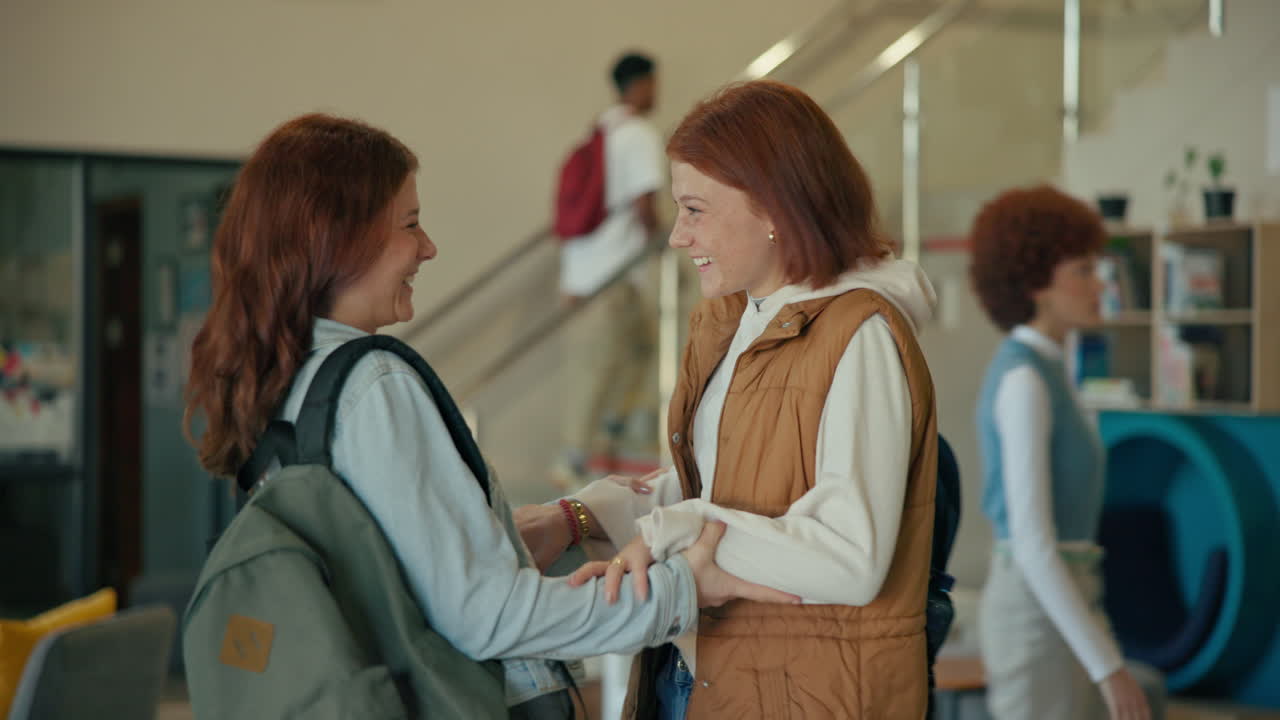 Two students meet at the library