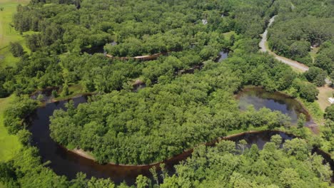 slow aerial flyover shot above schroon river and greenery in upstate new york, usa