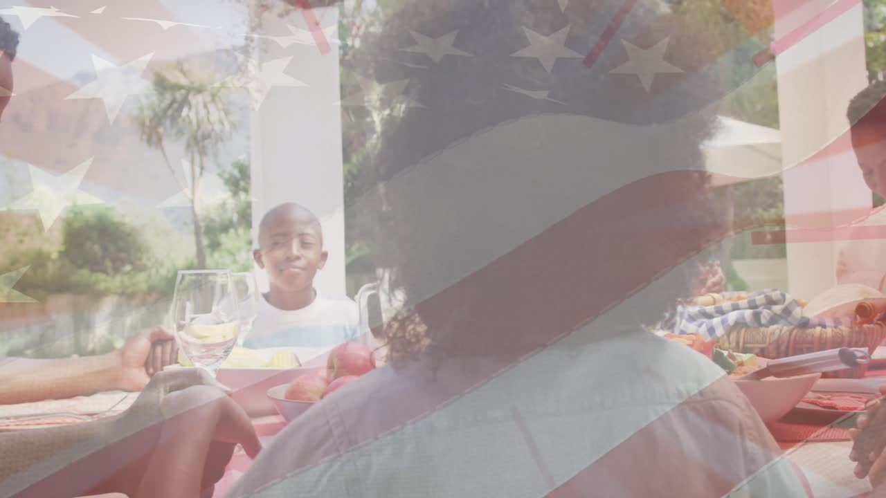 animación de la bandera de los estados unidos sobre una familia afroamericana cenando