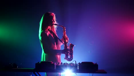 woman playing saxophone and djing