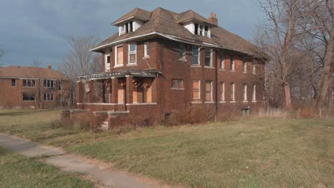 drone view of dilapidated house in a detroit neighborhood