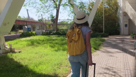 traveler in casual outfit exploring green city area