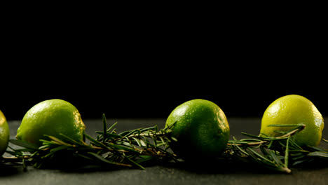 lemon and rosemary arranged against black background 4k