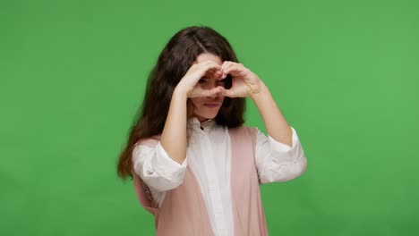 curious teenage brunette girl in white shirt looking around with attentive inquisitive view, observing world through binoculars