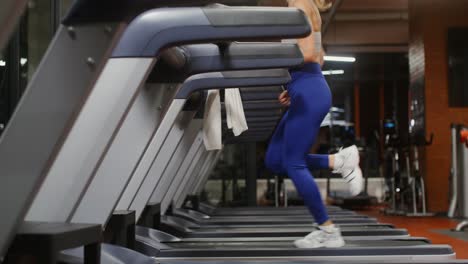 woman running on treadmill in gym