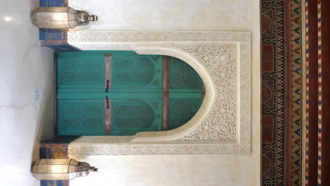 vertical shot of a blue turquoise islamic door inside a palace of marrakesh