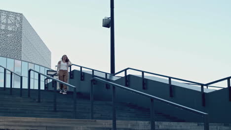 woman walking up stairs in a city