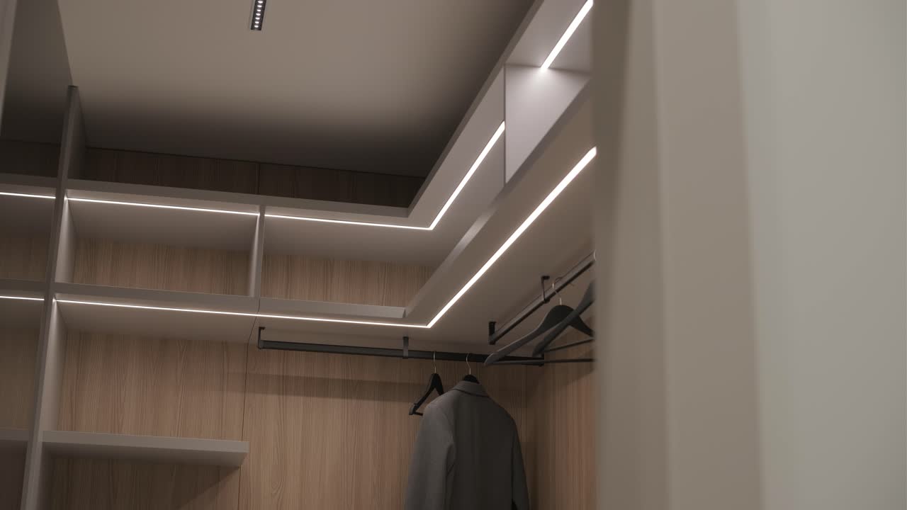 끔한 디자인과 조직된 공간을 특징으로 하는 led 조명과 목조 선반이 있는 현대적인 옷장 내부 전망