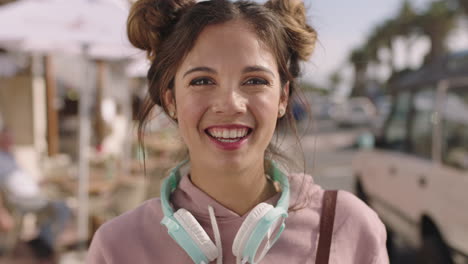 portrait of young beautiful hispanic woman laughing cheerful happy on sunny beachfront wearing headphones
