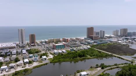 Gulf-Shores,-Alabama-skyline-and-beach-with-drone-video-moving-in-wide-shot