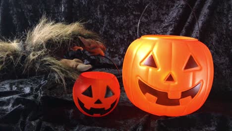 monster arm grabs happy halloween pumpkin pail and pulls it out of frame